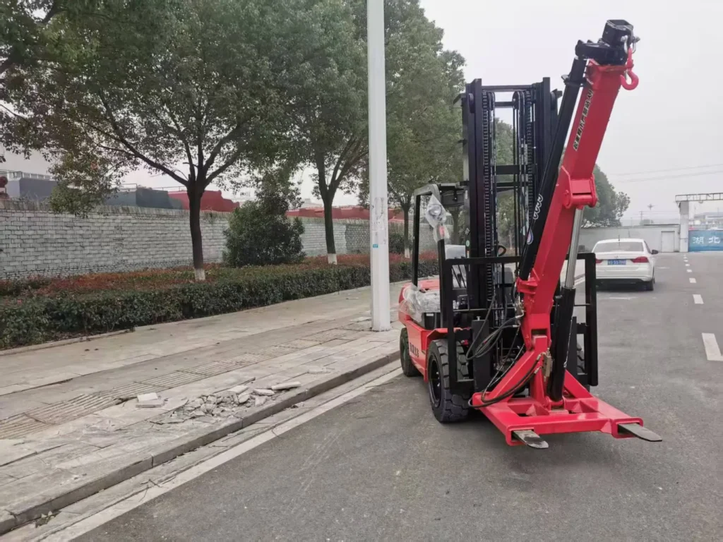 Customer's red forklift featuring a CC55 forklift crane attachment, a practical **forklift jib crane setup, parked outdoors.