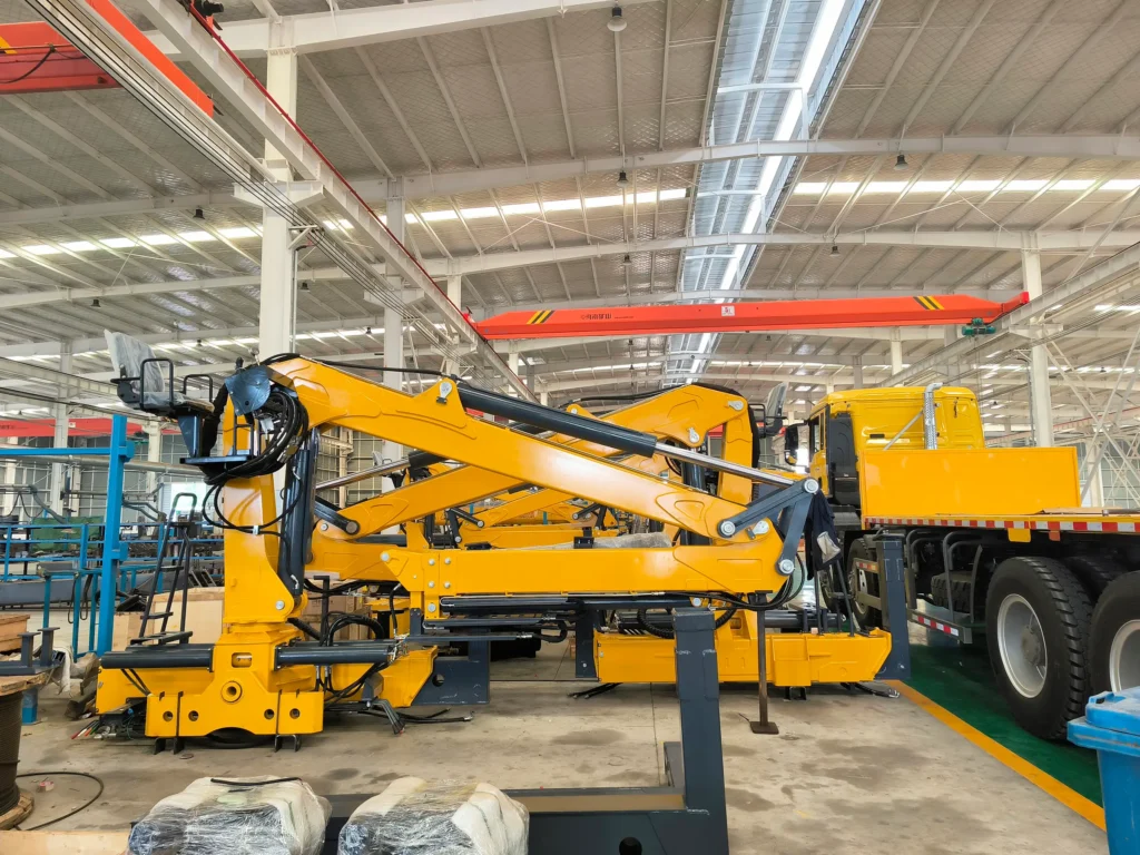 Factory snapshot of a yellow Q160LA2 knuckleboom log loader, an example of a timber crane for sale, built for a specific customer.