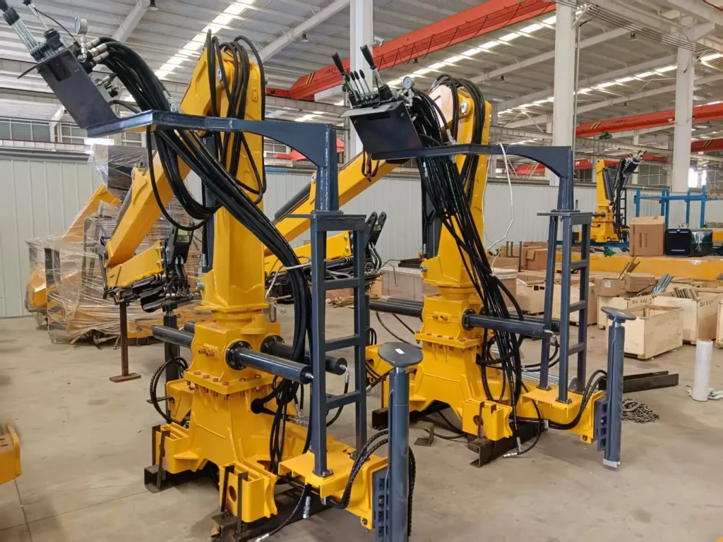 Yellow ZM66.2 forestry cranes ordered by a customer, designed to be truck mounted cranes, pictured in the production facility.